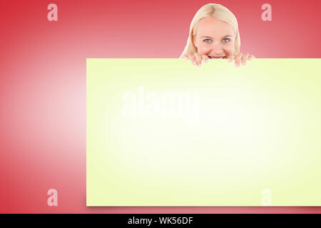 Composite image of pretty blonde showing yellow card Stock Photo