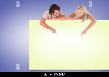 Composite image of attractive couple showing yellow card Stock Photo