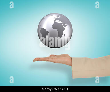 Female hand presenting globe against blue vignette Stock Photo
