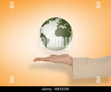 Female hand presenting earth against orange vignette Stock Photo