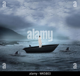 Composite image of asian businesswoman in a sailboat being circled by sharks Stock Photo
