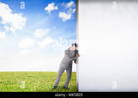 Composite image of businessman pushing away scene to serene landscape Stock Photo