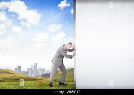 Composite image of businessman pushing away scene of grey room Stock Photo