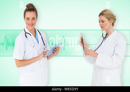Composite image of medical team against green medical background with ecg line Stock Photo