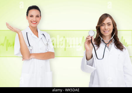 Composite image of medical team against medical background with green ecg line Stock Photo