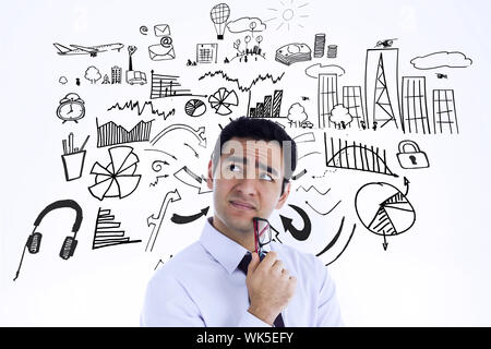 Thinking businessman holding glasses against brainstorm graphic Stock Photo