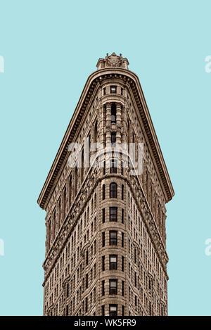 New York City, USA - June 20, 2018: Flatiron Building in Manhattan. Low angle view against flat blue sky. It is one of the worlds most iconic skyscrap Stock Photo