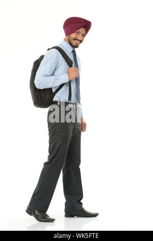 Indian salesman walking with backpack Stock Photo
