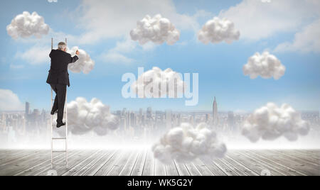 Mature businessman climbing career ladder against white cloud computing clouds Stock Photo