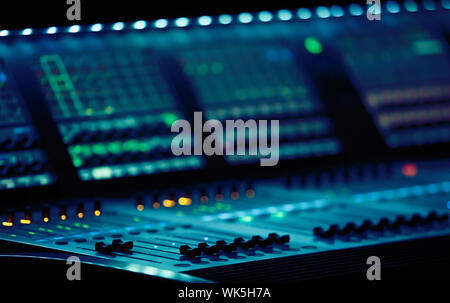 Professional concert sound mixer console on backstage.Industrial audio mixing controller panel with touch screen monitors and volume sliders to contro Stock Photo