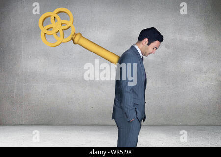 Composite image of wound up businessman with hands in pockets against grey room Stock Photo