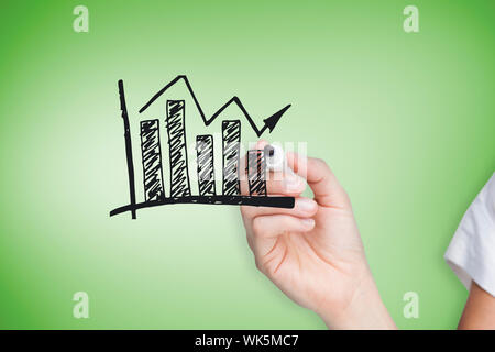 Composite image of businesswoman drawing graph against green vignette Stock Photo