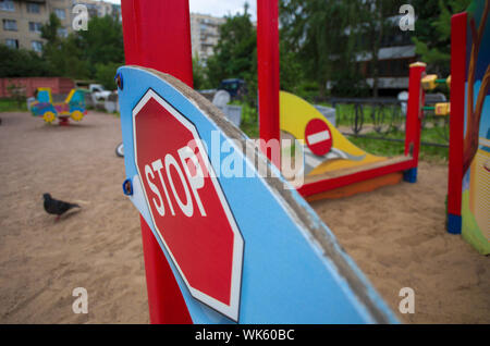 Red road sign 'Stop' in miniature obliquely and the sign 'No entry' on the blurred background of the Playground Stock Photo