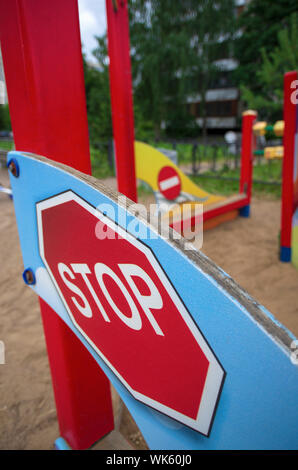 Red road sign 'Stop' in miniature obliquely and the sign 'No entry' on the blurred background of the Playground Stock Photo