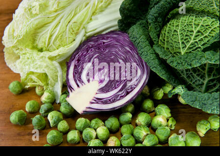 Still life with assortment cabbages on wooden table Stock Photo