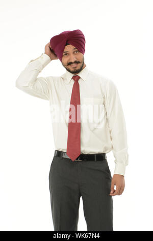 Businessman scratching his head and looking confused Stock Photo