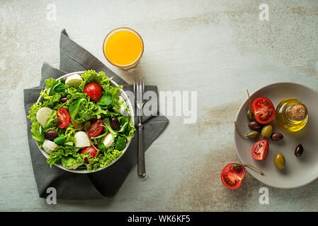 Healthy green salad with tomato and mozzarella cheese. Home made food. Concept for a tasty and healthy meal Stock Photo