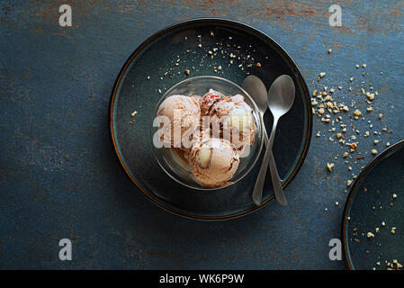 Homemade Organic Ice cream scoops with chocolate and nuts in a plate close up Stock Photo