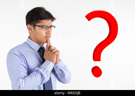 Side profile of a businessman thinking with question marks Stock Photo