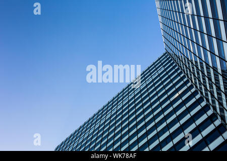 Exterior of building - abstract concept; skyscraper from down below against blue sky Stock Photo