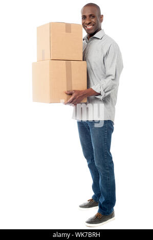 Handsome male with with stack of boxes isolated on white Stock Photo