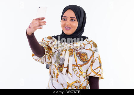 Happy young beautiful African Muslim woman taking selfie Stock Photo