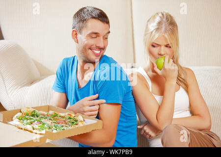 couple eating different food Stock Photo