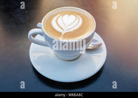 Fresh cappuchino or flat white coffee with latte art close-up Stock Photo