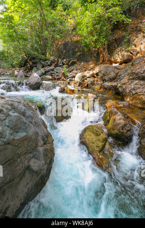 Water cascade flowing through big rocks in Kazdagi Forest (Mount Ida) in Canakkale, Turkey. Portrait Shot. Big rocks on the foreground. Stock Photo