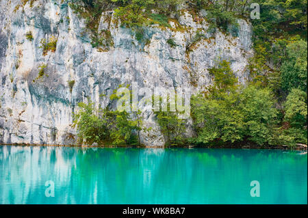 turquoise lake water on the background of rocks Stock Photo