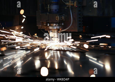 Laser metall cut cnc machine. Fly fire sparks background. Stock Photo