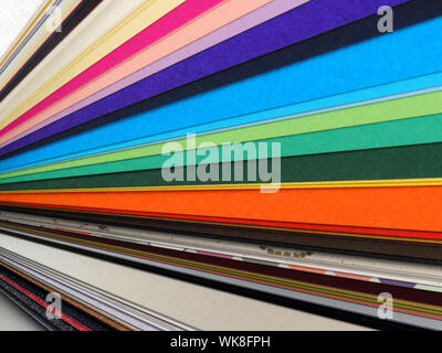 Colored samples of different papers on white background, business cards Stock Photo