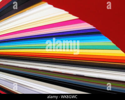 Colored samples of different papers on white background, business cards Stock Photo