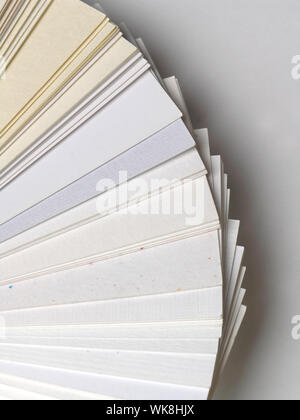 Colored samples of different papers on white background, business cards Stock Photo