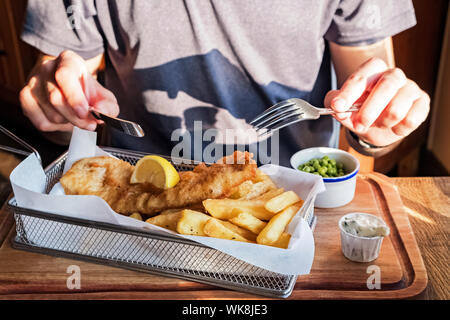 Close-up shot of man going to eat fish and cheaps. Stock Photo