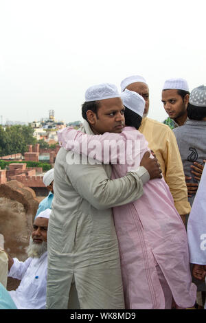 Muslim men hugging to each other, Jama Masjid, Old Delhi, India Stock Photo