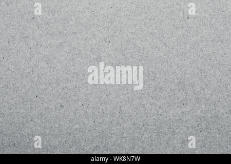 Kraft paper texture. Gray carton surface, rough material. Grey packaging background, dirty card backdrop. Vintage paper sheet pattern. Stock Photo