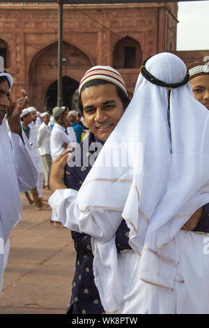 Muslim men hugging to each other, Jama Masjid, Old Delhi, India Stock Photo