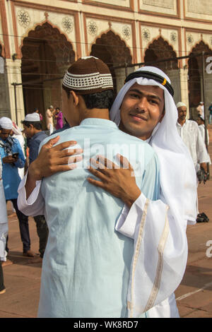 Muslim men hugging to each other, Jama Masjid, Old Delhi, India Stock Photo