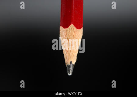 Red graphite pencil in vertical isolated on a white background Stock Photo