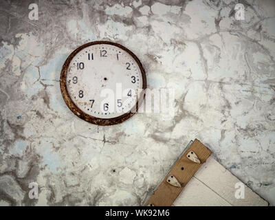 Old broken rusty clock on the wall inside of the abandoned Pripyat Elementary School No. 3 in Pripyat city, Chernobyl Exclusion Zone, Ukraine Stock Photo