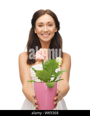 bright picture of lovely housewife with flower in pot Stock Photo