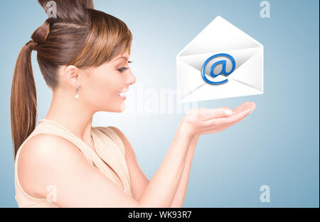 picture of smiling woman showing virtual envelope Stock Photo