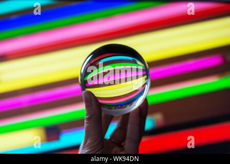Reflections of colorful neons in a crystal ball. Astract colorful photography. Stock Photo