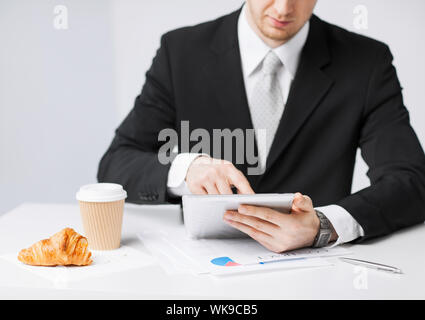 man with tablet pc and cup of coffee Stock Photo