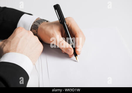 picture of businessman writing something on the paper Stock Photo