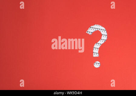 red paper teared to question mark symbol revealing more question mark on white paper. concept of FAQ, Q&A, search, riddle and information Stock Photo