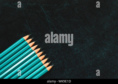 Lots of pencils on black board background with copy space. Back to school concept. Flat lay. Stock Photo