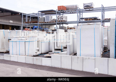 Cement building blocks stacked on pallets used for transportation and distribution at a hardware depot, warehouse or on a construction site Stock Photo