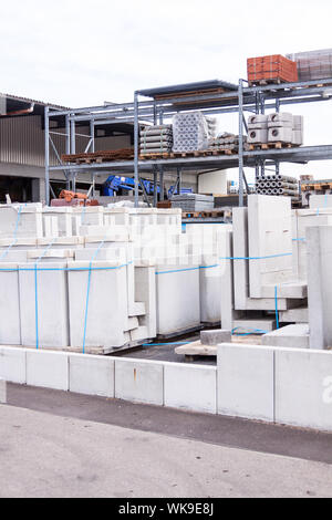 Cement building blocks stacked on pallets used for transportation and distribution at a hardware depot, warehouse or on a construction site Stock Photo